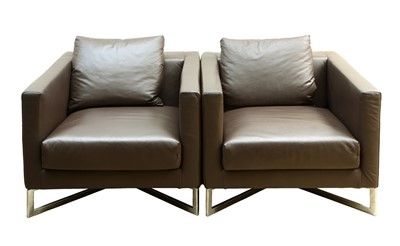 Lot 90 - A pair of brown leather arm chairs